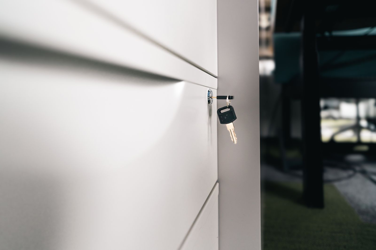 A key sitting in the lock of an office cabinet, representing control of business accounts
