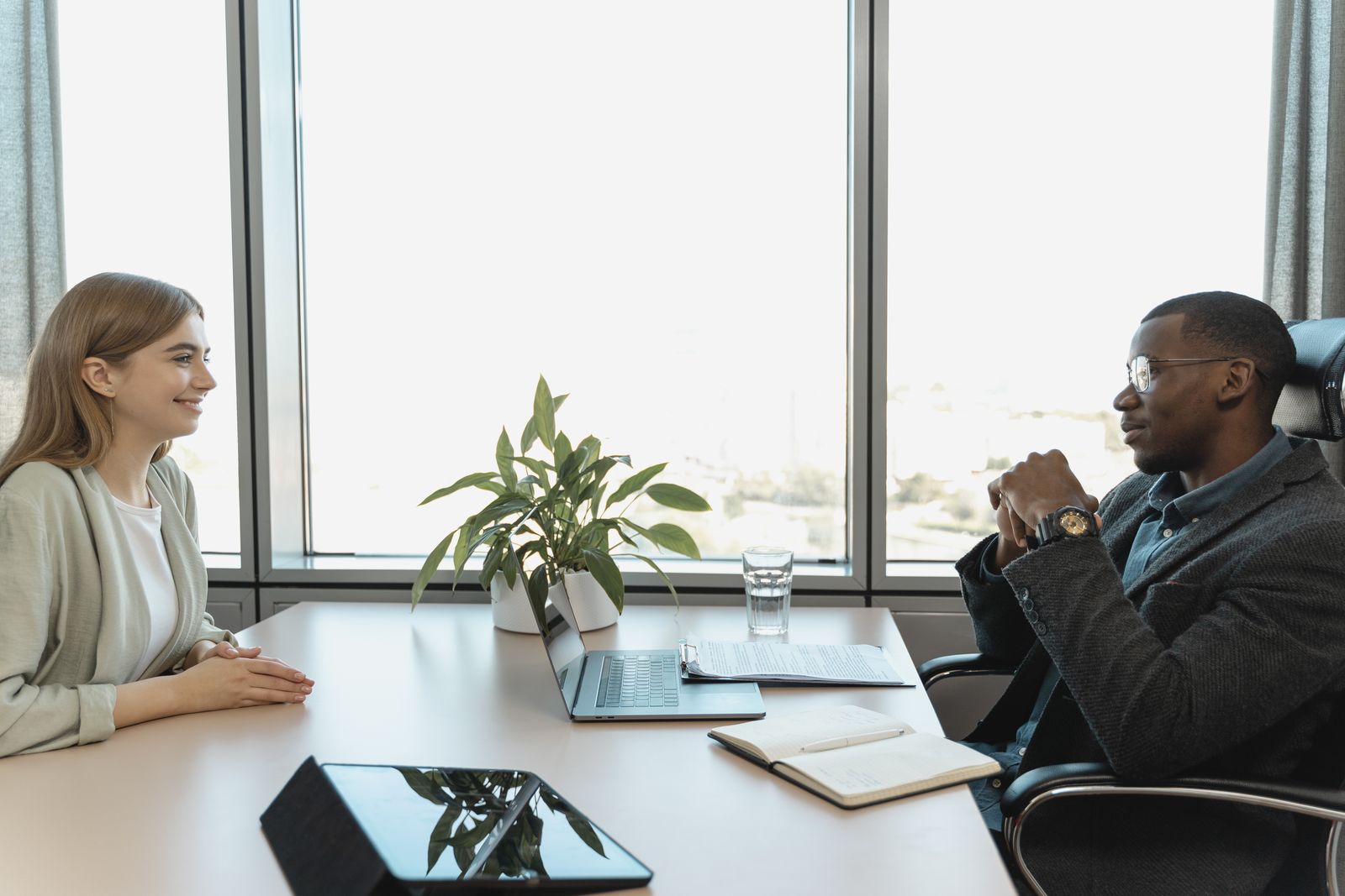 A business owner interviewing a marketing agency representative across a conference table