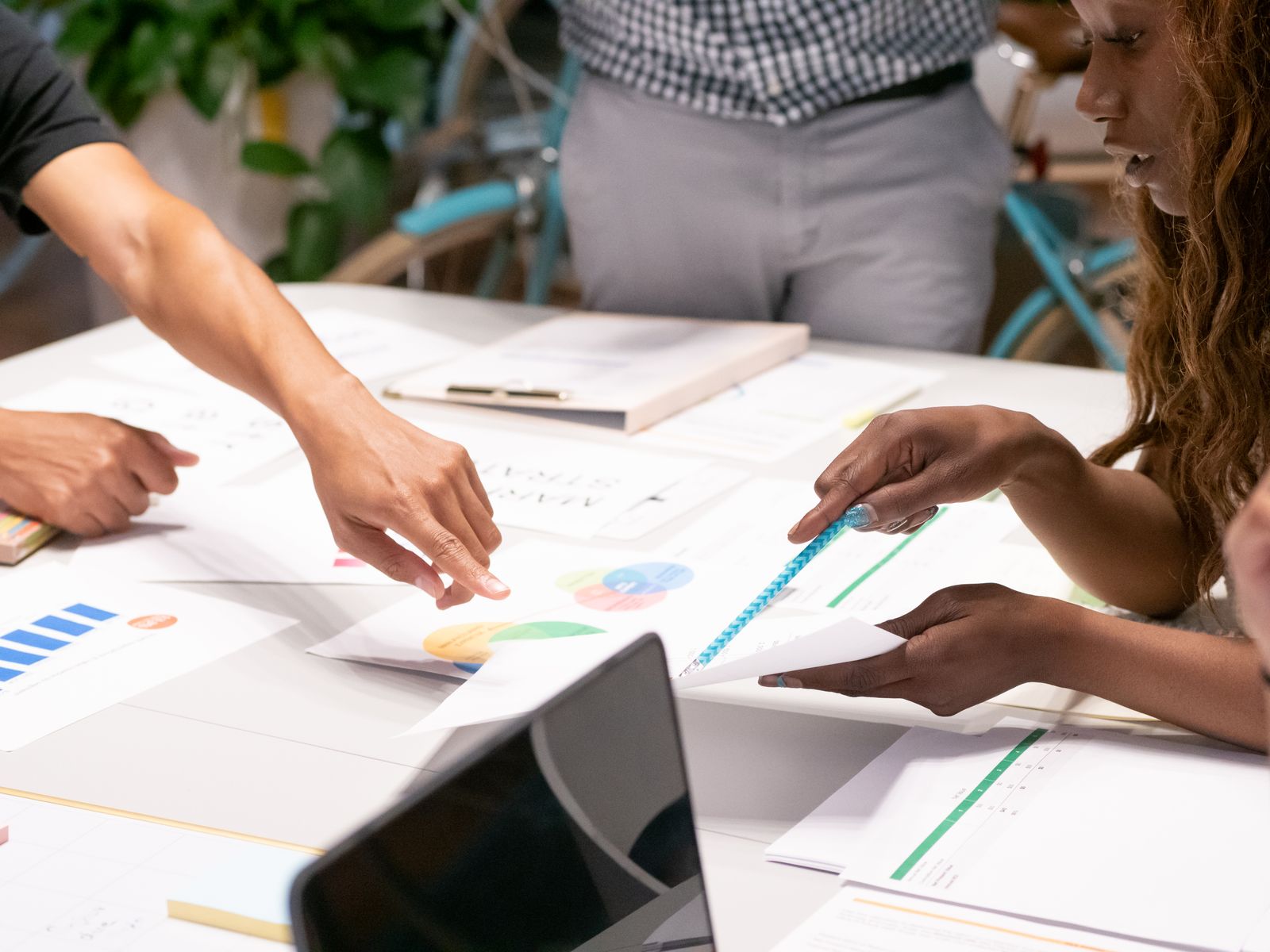 A marketing team reviewing strategy documents and charts around a table
