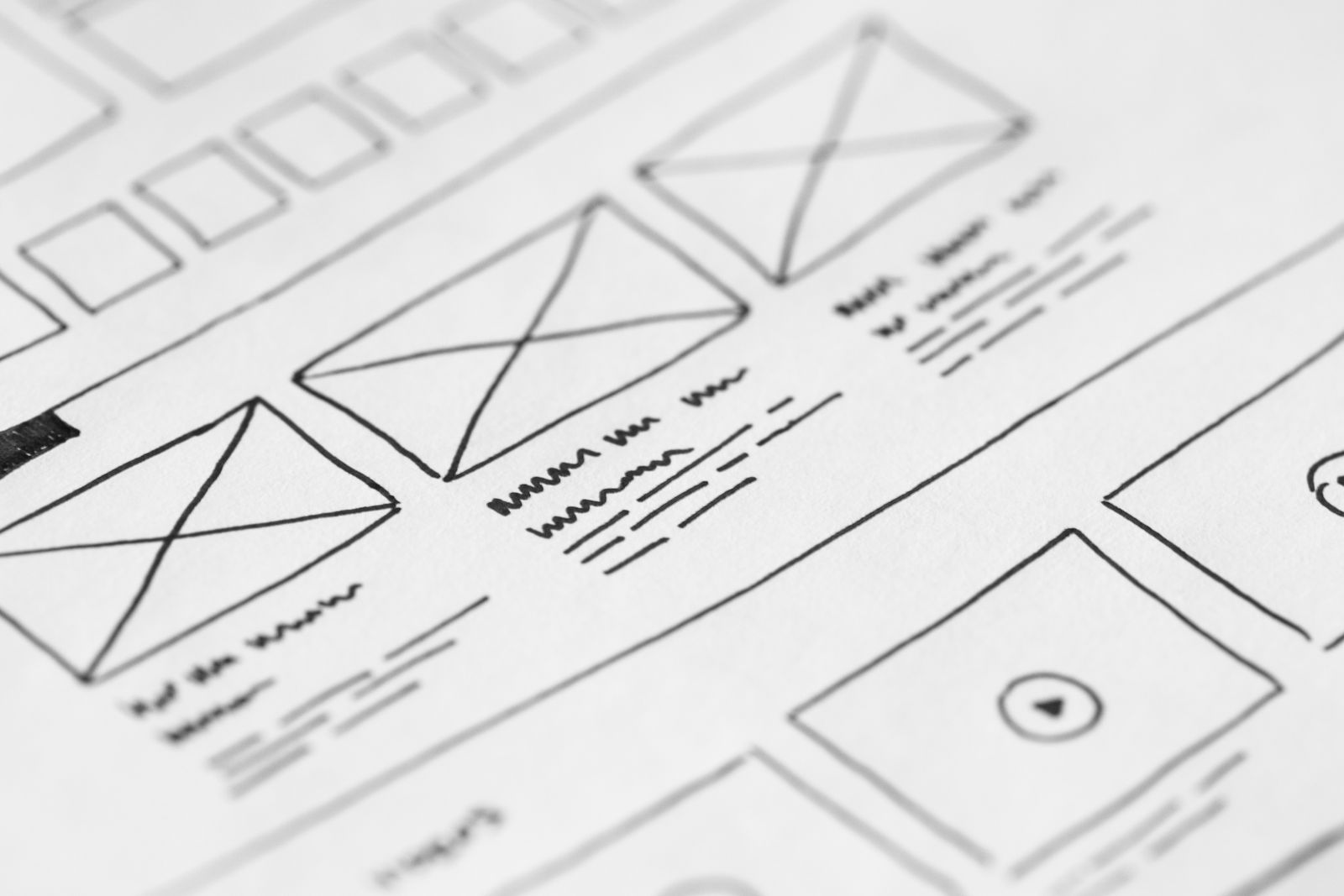 A hand-drawn website wireframe sketch showing repeated page blocks
