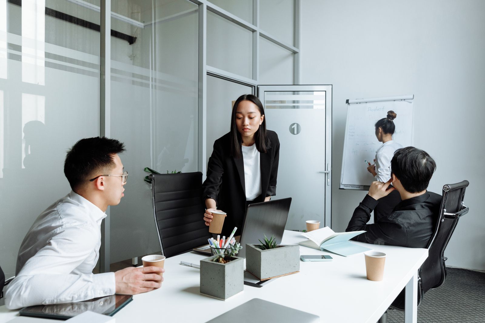 Colleagues discussing a decision around a table in a modern office