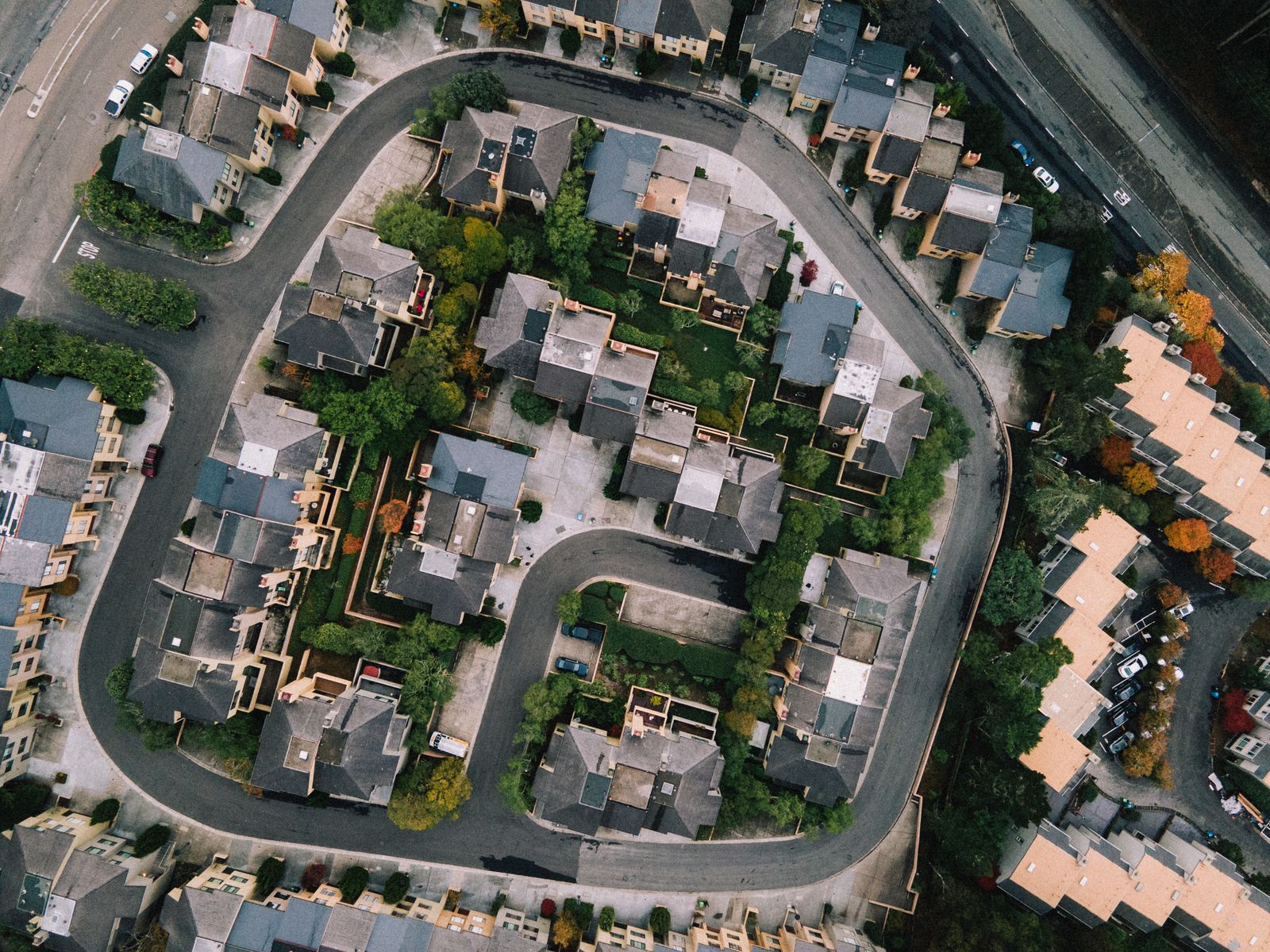 Aerial view of a suburban housing development and surrounding roads