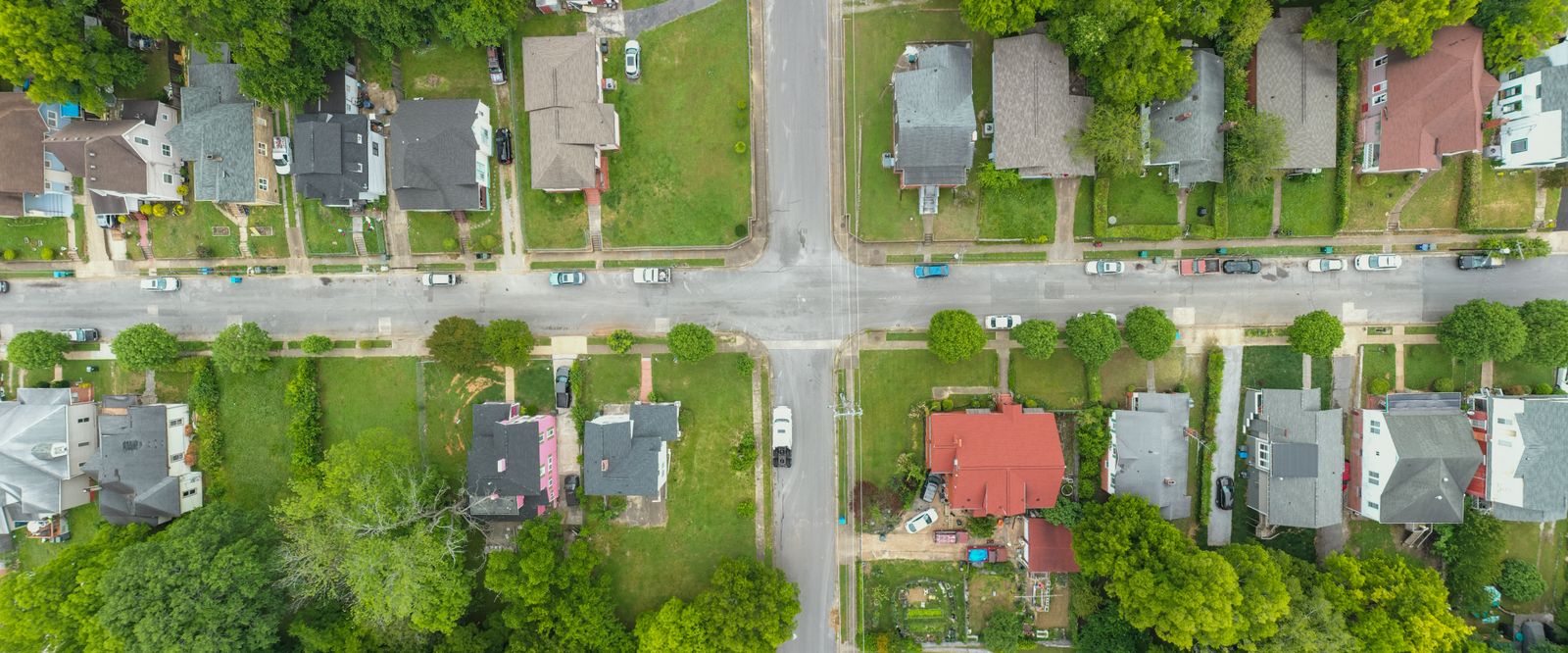 Overhead aerial view of a residential neighborhood intersection