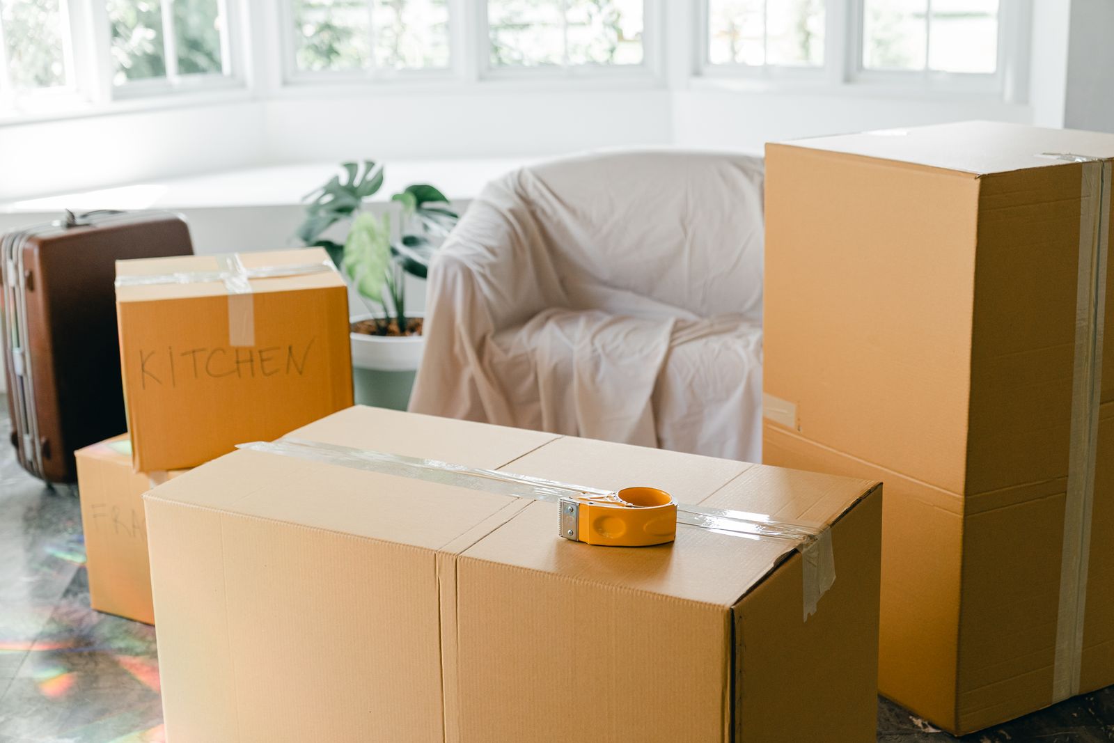 Packed cardboard moving boxes in an empty room, the physical equivalent of a website migration