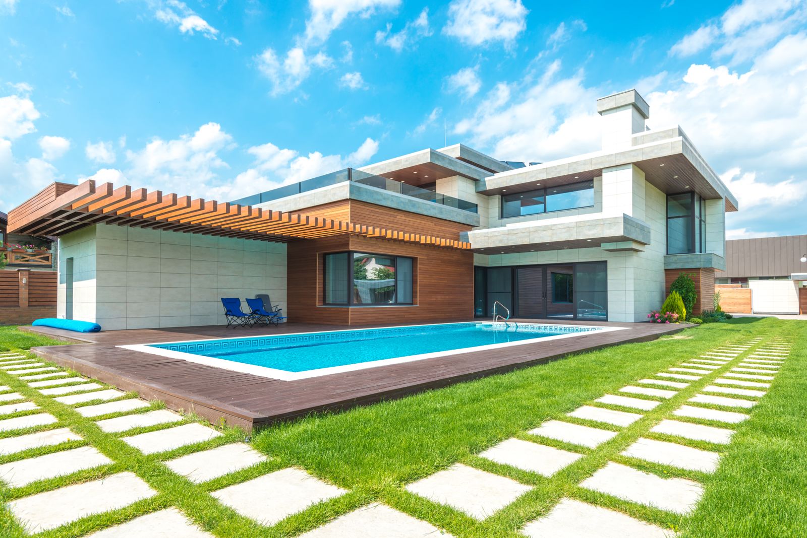 Modern home with a finished backyard swimming pool and deck
