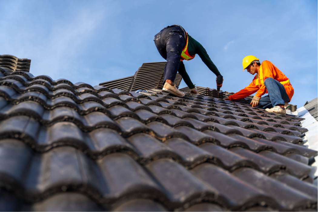 Roofing crew working on a residential roof replacement